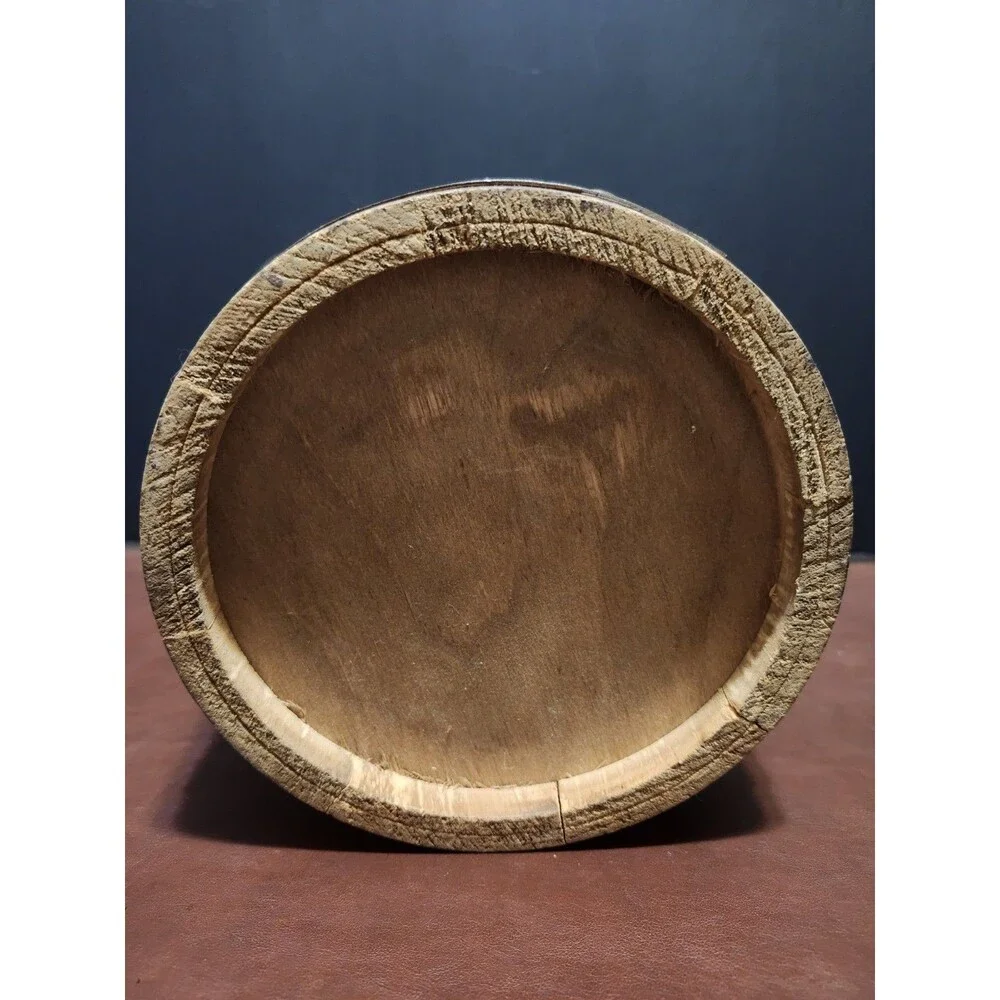 This is a vintage wood and brass barrel-style ice bucket typically measuring...
